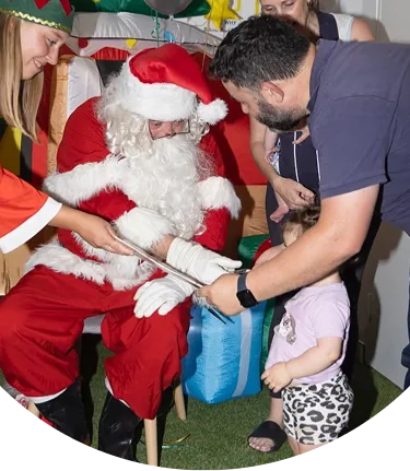 A community visitor sharing with children at the centre