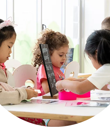 Educator supporting children during a counting activity
